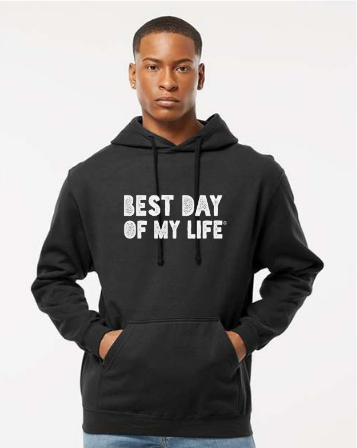 dark-skinned person with short hair wearing a black pullover hoodie with best day of my life written in white block lettering