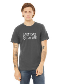 young white man wearing a grey crewneck t-shirt with best day of my life written across in white