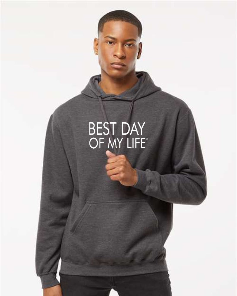 dark-skinned person with short hair wearing a grey pullover hoodie with best day of my life written in white