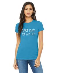 medium skinned person wearing a aqua fitted crewneck t-shirt with best day of my life written across in white with a cross in the O