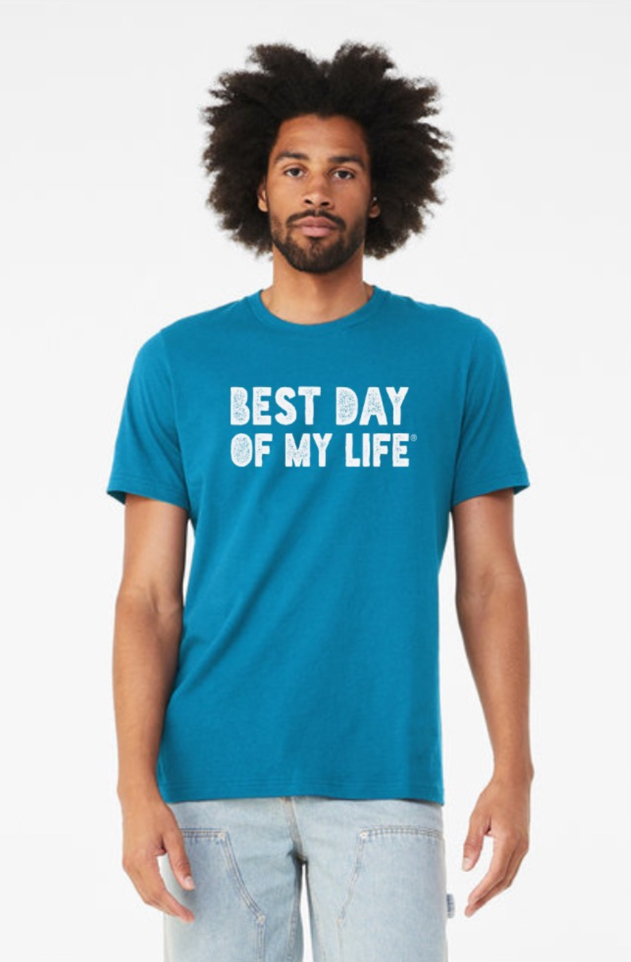 young black man with an afro wearing an aqua crewneck t-shirt with best day of my life written across in white block lettering