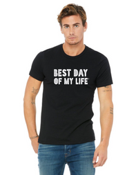 white man with wearing a black crewneck t-shirt with best day of my life written across in white and jeans