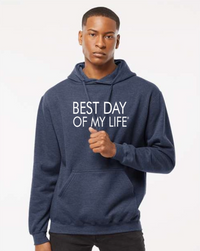 dark-skinned person with short hair wearing a blue pullover hoodie with best day of my life written in white