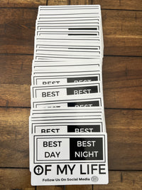 Thumbnail for stack of stickers on wooden background, graphic of a white and black sticker on a grey background. sticker reads best day best night of my life with a cross